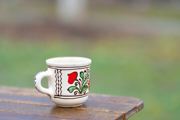 clay mug with traditional Romanian motifs placed on a table. traditional.