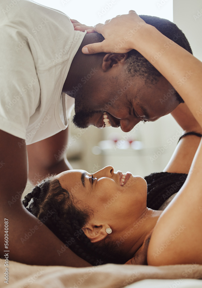 Wall mural Black couple, love and home bedroom romance while happy and intimate together on bed at home, apartment or hotel. Face of young man and woman in happy marriage with commitment and care on honeymoon