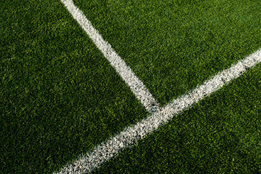White lines at football pitch with artificial grass.