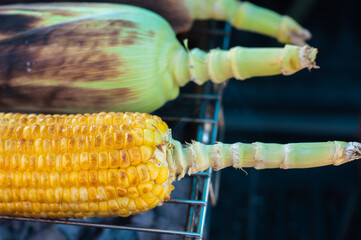 Traditional charcoal-grilled sweet corn with salted butter