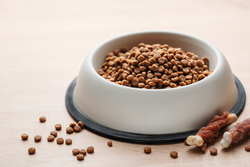 A bowl of dog food on a wooden floor.