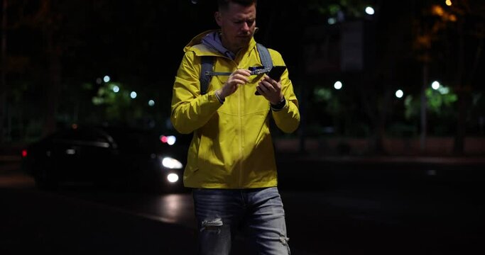 Emotions of sadness man reads message and dejectedly sit down on street and hold on to head