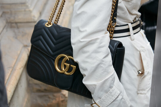 Woman with black leather Gucci bag with golden logo on September 21, 2022 in Milan, Italy