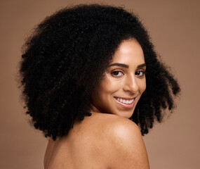 Fototapeta na wymiar Black woman, studio portrait and beauty with smile, cosmetic glow and healthy with afro by backdrop. Model, skincare and natural hair care for aesthetic, wellness and self care by brown background