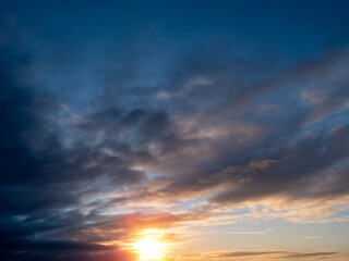 Beautiful cloudy sky with rich blue color at sunset. Nature background for design and sky replacement.