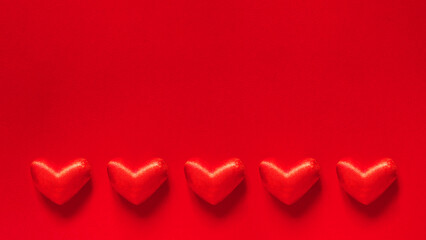 Valentine's day banner with five red hearts on a red background with space for text. love and...