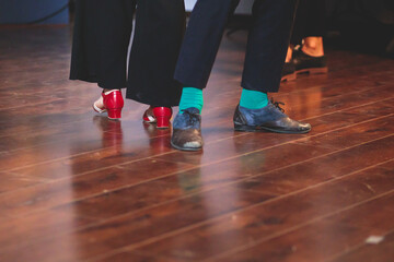 Dancing shoes of young couple dance retro jazz swing dances on a ballroom club wooden floor, close...