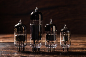 Vacuum electronic radio lamps tube standing on a wooden boards