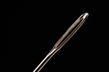 Macro of a needle, needle's eye with isolated on black background focus stack image