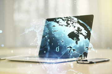Multi exposure of abstract software development hologram with world map on laptop background, global research and analytics concept