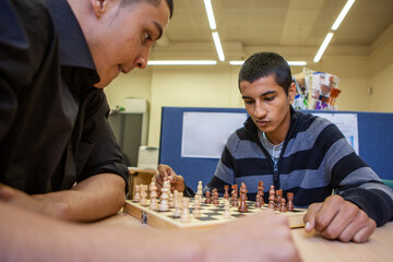 Gaming Teenagers: Chess Players. Intense concentration on the face of a late teenage boy enjoying a...