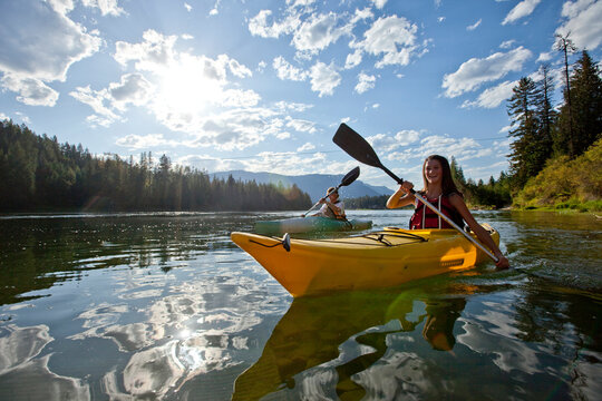 Young Adult Couple Kayak On A Beautiful Summer Day In Idaho.