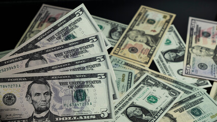 Banknotes of 5 US dollars, Stacks of money from a banknote of 5 dollars, top view.
five dollar bill...