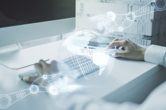 Creative abstract robotics technology hologram with globe and hands typing on computer keyboard on background, artificial intelligence and machine learning concept. Multi exposure