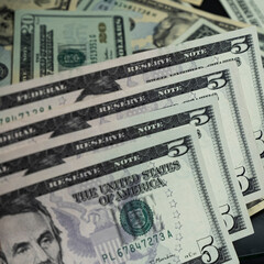 Banknotes of 5 US dollars, Stacks of money from a banknote of 5 dollars, top view.
five dollar bill...