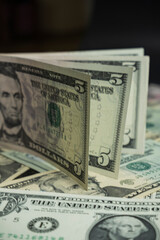 Banknotes of 5 US dollars, Stacks of money from a banknote of 5 dollars, top view.
five dollar bill...