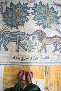 rom the view point of a traveler looking down at an Arabic mosaic on the floor of a church at the baptism site of Jesus Christ in Jordan