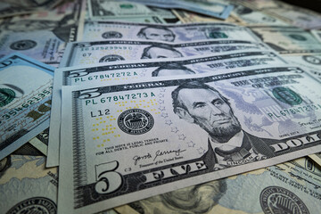 Banknotes of 5 US dollars, Stacks of money from a banknote of 5 dollars, top view.
five dollar bill...