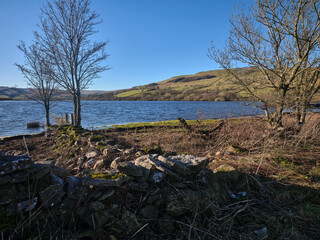 With a submerged gate and fence, From the northern shore of Semerwater, looking north west towards Green Scar Mire Crag. Raydale. North Yorkshire