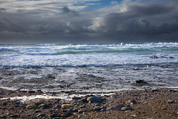 Storm approaching a rocky Cornish beach