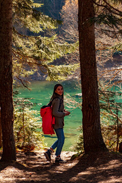 Nice Girl traveller descends to mountain lake