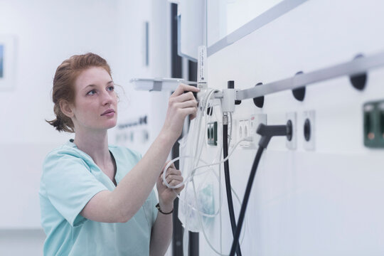 Female nurse adjusting oxygen valve