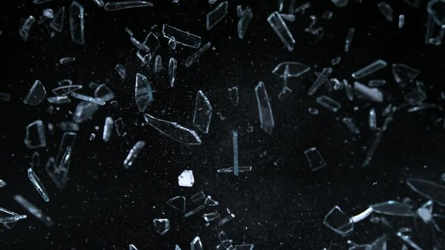 Super Slow Motion Shot of Shattering Glass Shards Flying Towards Camera on Black at 1000fps.