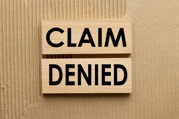 Claim Denied. wood blocks on a brown background. text on wood. Warranty concept.