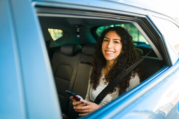 Young woman texting and using the rideshare app