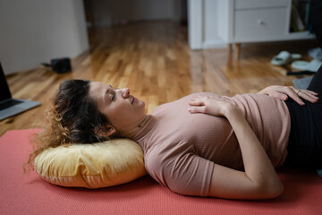 One adult caucasian woman practice restorative yoga at home