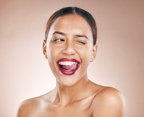 Makeup, beauty and lipstick on a woman with tongue on teeth for cosmetics on a studio background for dermatology, color and salon mockup. Face of aesthetic model with a smile, glow and healthy skin