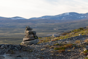 Fototapeta na wymiar mountain landscape that can be seen from the viewpoint Snøhetta in Dovre Municipality with a cairn in the foreground