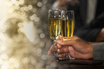 To raise wine or champagne glasses in a group salute and clink them together in celebration of a party. 