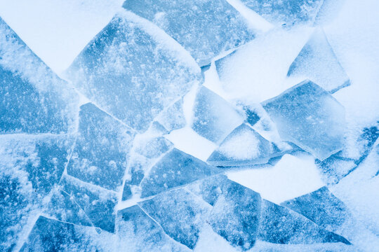 Background of broken ice. Abstract beautiful blue ice crack texture