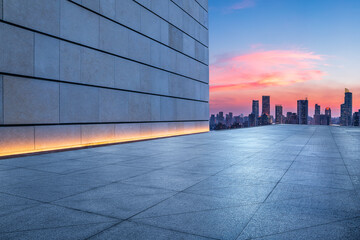 Fototapeta na wymiar Empty square floor and wall with city skyline at sunset in Shanghai, China.