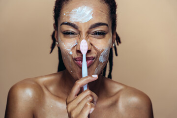 Beautiful woman making skin and facial beauty treatments. Studio shot with focus on cosmetic and skin care concepts
