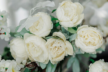 Details. Wedding Decor. On a gray textural background ,  a bouquet of dried flowers, tulips and white wild flower.wedding decorated white flowers .Beautiful wedding decor.Place for wedding ceremo