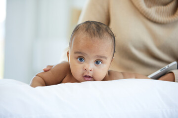 portrait cute baby crawling and looking to something on bedroom