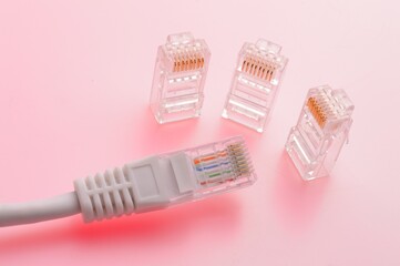 Connector rg 45 for internet cable. Several connectors lie on a multi-colored background. Close-up