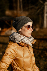 Frau, 40+, im Winteroutfit mit Sonnenbrille