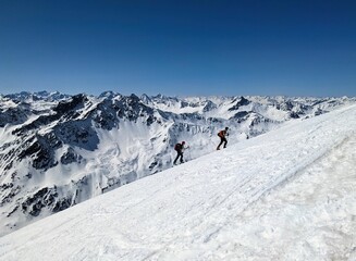 Ski touring group on the ascent towards the Schwarzhorn near Davos. Mountains. Ski mountaineering in the Swiss Alps