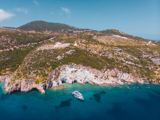 Drone shot of Zakynthos island with beautiful turquoise Ionian sea and limestone cliffs and cave near famous Navagio beach during daytime - 560110095