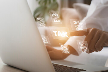Business using a computer to complete Individual income tax return form online for tax payment with business icon.
