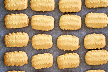 Baked Christmas cookies on a baking sheet, top view