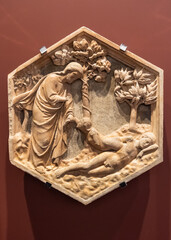 Close-up on religious scene carved in a marble decorative object showing Jesus ressuscitating dead naked men
