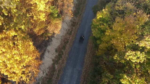 Man riding 4 wheeler on a sunny mountain road in Central Pennsylvania USA