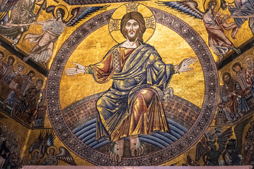 Golden religious mosaic of Jesus decorating wall inside catholic church in Florence