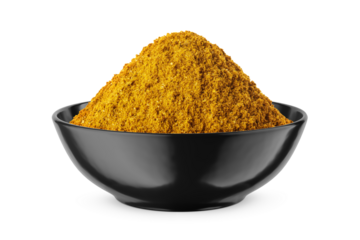 Curry powder in round black bowl isolated on white. Front view.
