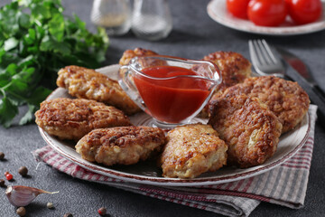 Cutlets of turkey fillet and oatmeal, fried in a pan, served with tomato sauce, Close-up