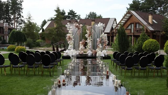a beautiful arch for a wedding ceremony in a park with chairs